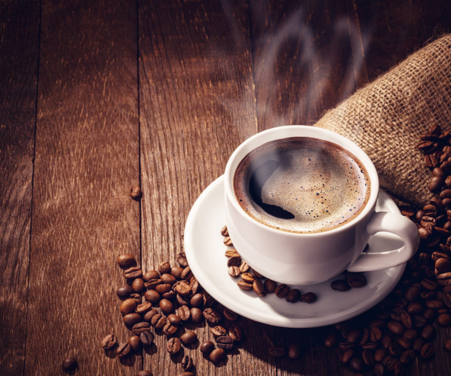 Cup coffee beans wooden dark background